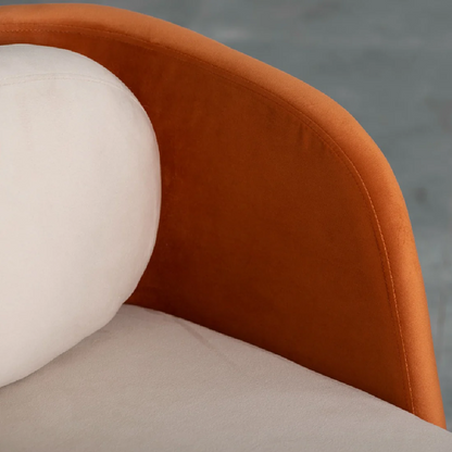 Close-up of a brown armchair with a white cushion and gray pillow.