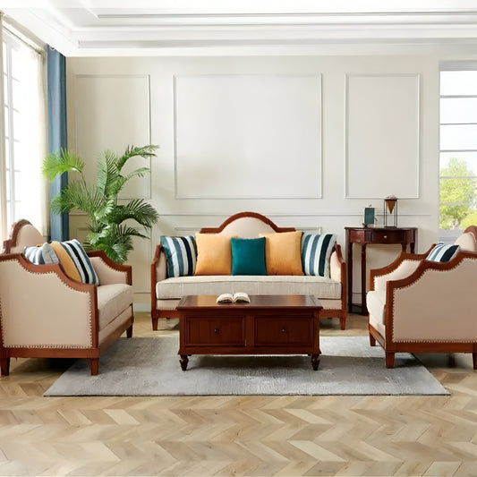 Living room with wooden coffee table, beige armchairs, and a sofa with colorful cushions.