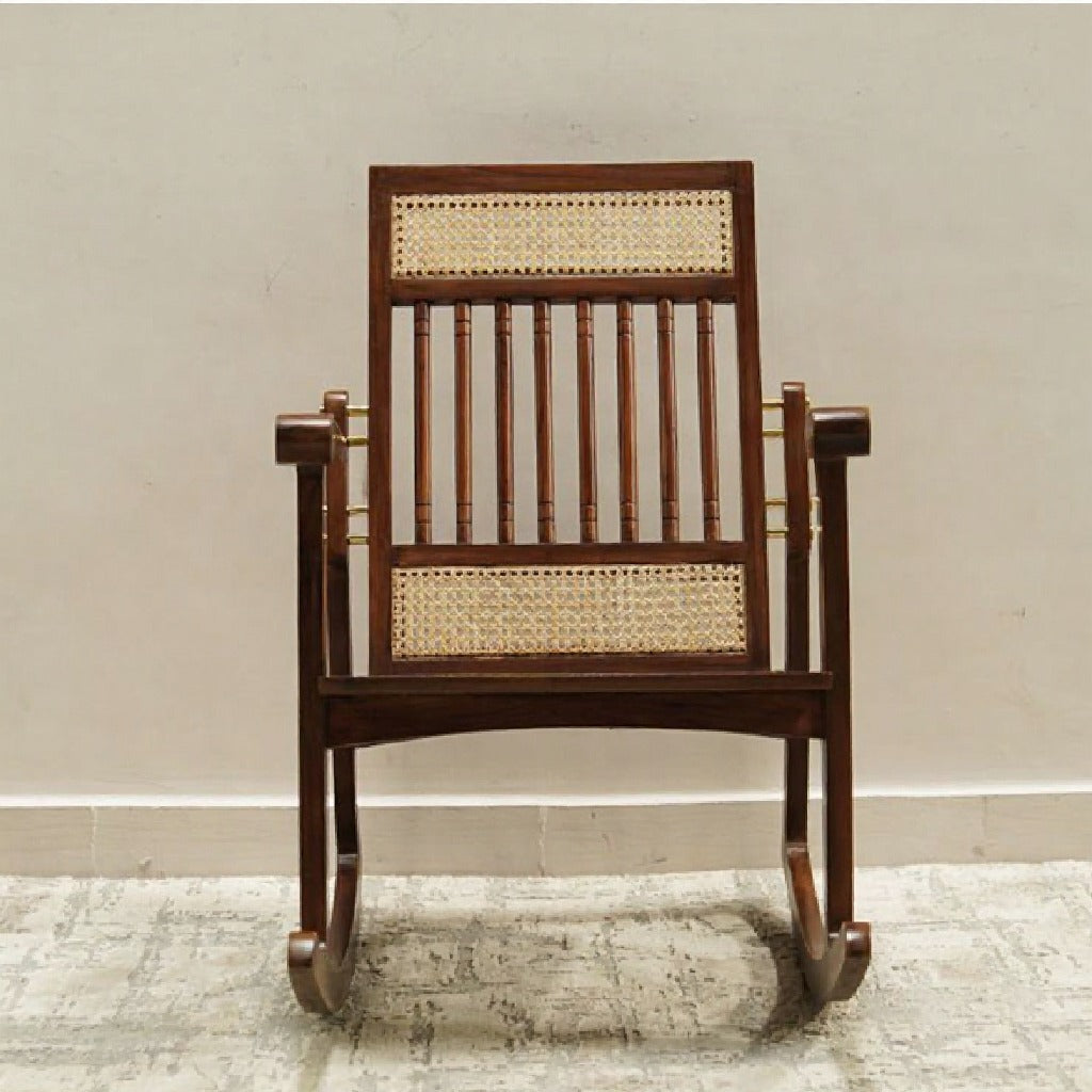 Wooden rocking chair with wicker back and seat on a neutral background