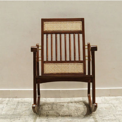 Wooden rocking chair with wicker back and seat on a neutral background