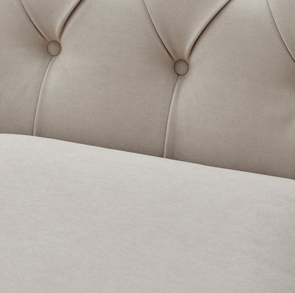 Close-up of a beige upholstered headboard with tufted design.