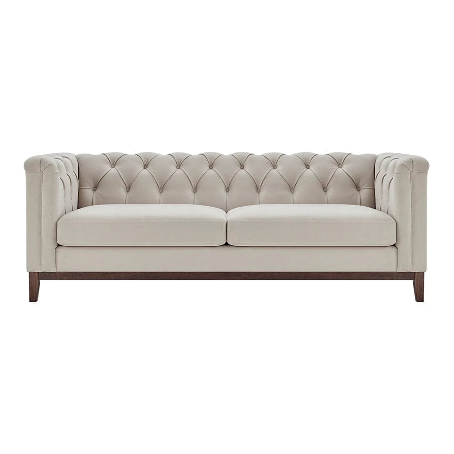 Beige tufted sofa on a white background
