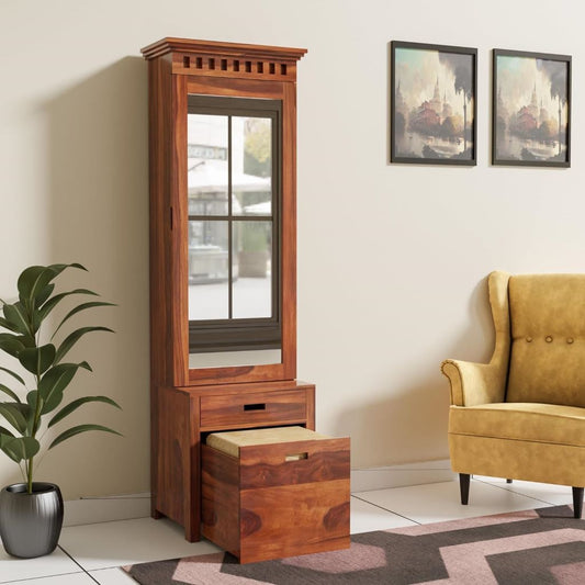 Wooden tall cabinet with mirror in a living room setting with a yellow armchair and plant.