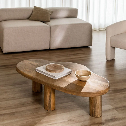 Wooden coffee table in a living room with a sofa and chair.
