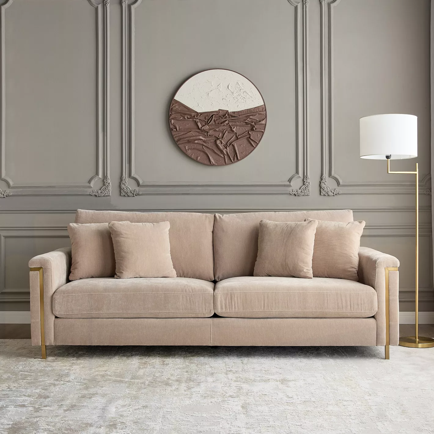 Beige sofa in a stylish room with decorative wall art and lamp.