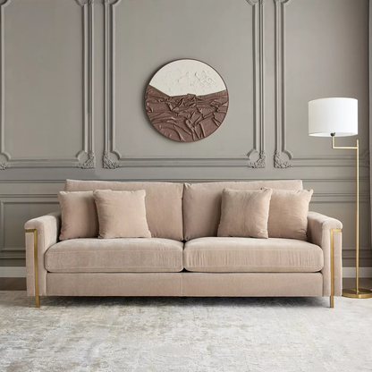 Beige sofa in a stylish room with decorative wall art and lamp.