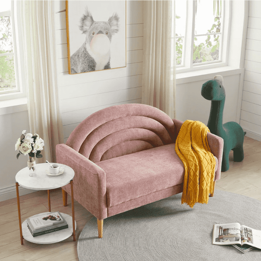 Pink children's sofa with a yellow blanket in a room with a dinosaur toy and a painting of a koala.