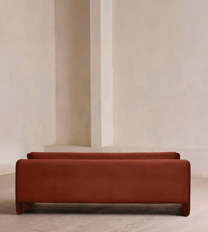 Two brown benches against a neutral wall.