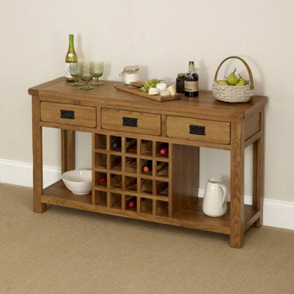 Wooden console table with wine rack and various items on a beige carpeted floor.