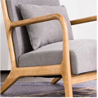 Gray cushioned chair with wooden frame on a light background