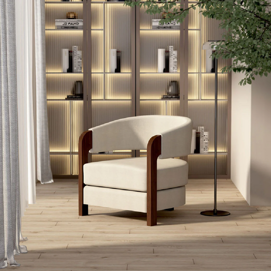 Modern white armchair with wooden frame in a stylish room with shelves and decor.