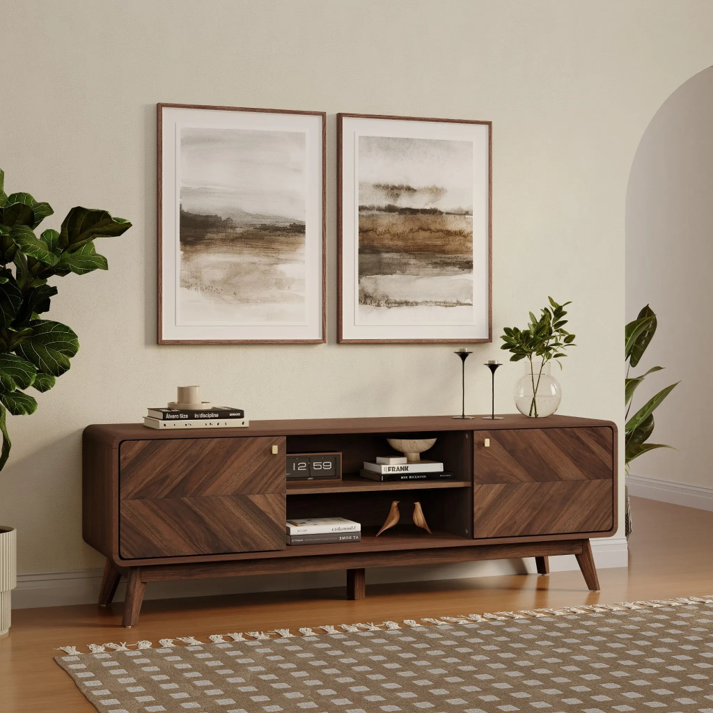 Wooden entertainment console in a living room with framed abstract art and decor items.