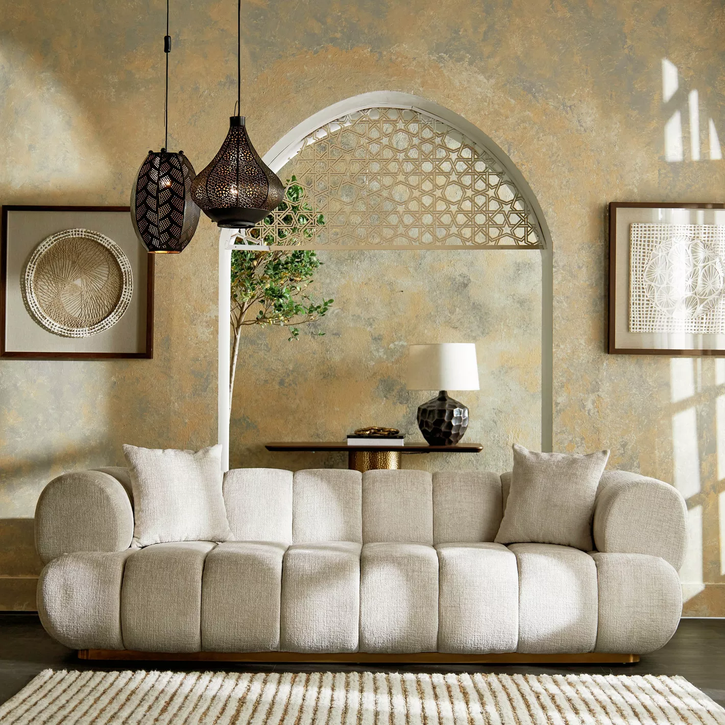 Living room with a beige sofa, decorative pillows, and wall art.