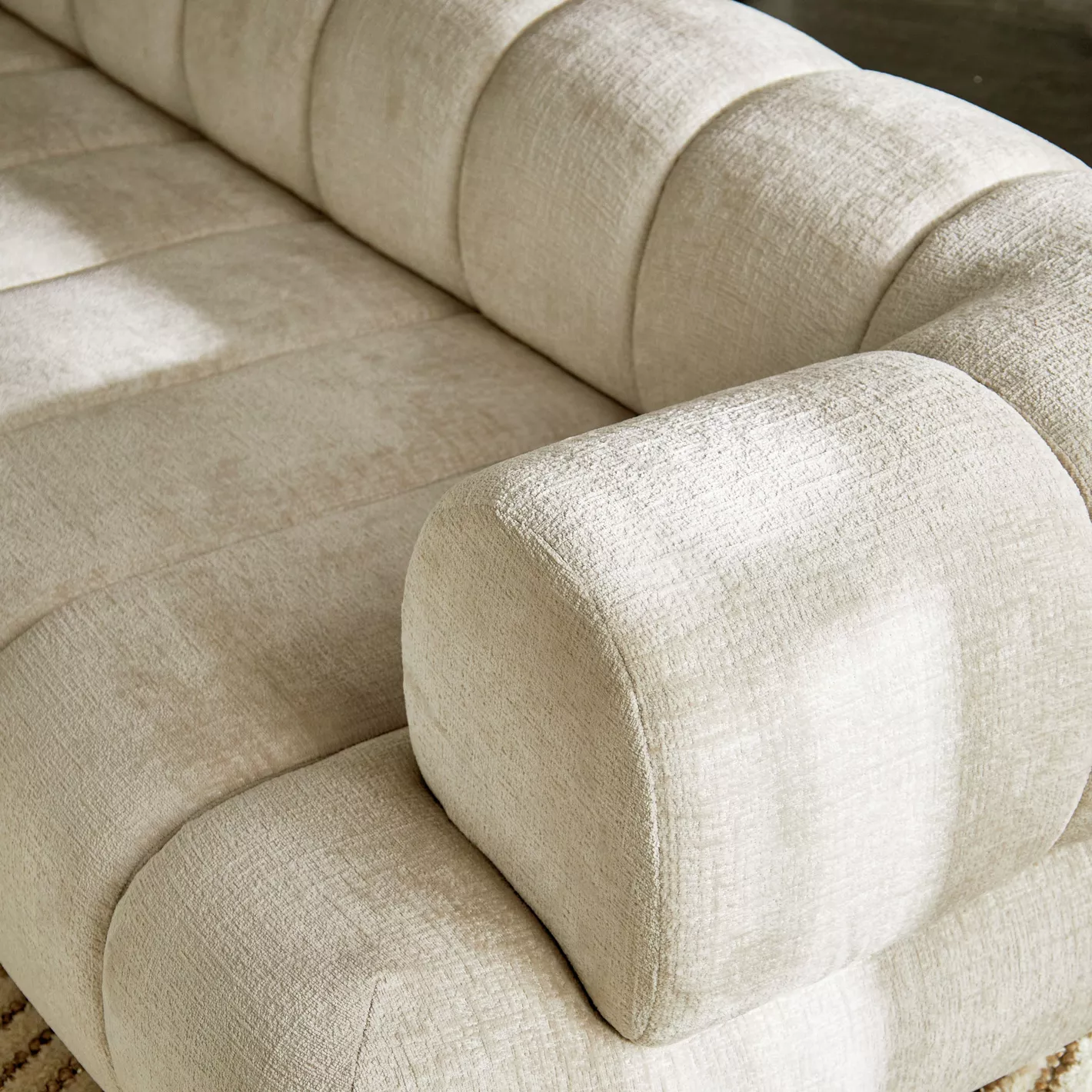 Close-up of a beige fabric sofa with a soft texture.