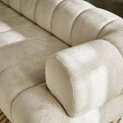 Close-up of a beige fabric sofa with a soft texture.