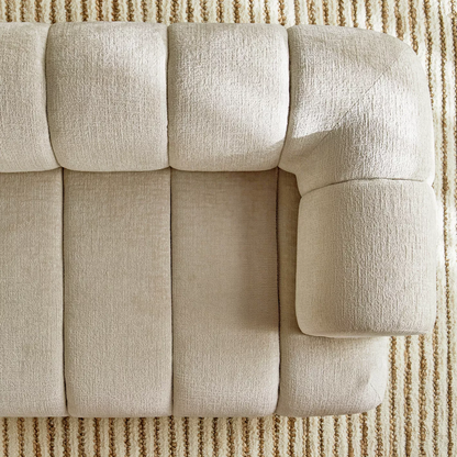 Beige sofa with a textured fabric on a matching carpet