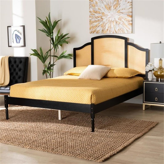 Bedroom with a black and gold bed frame, yellow bedding, and decorative elements.
